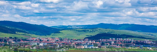 Preview: Rural houses and mountains under a cloudy sky in Gheorgheni, Harghita County, Romania