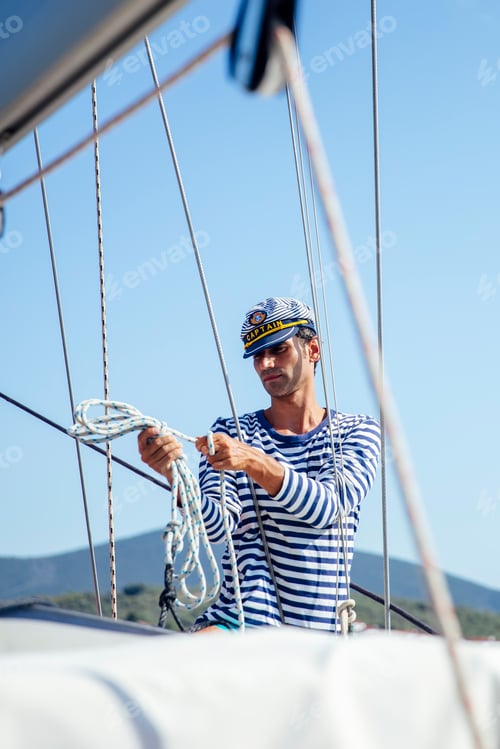 Preview: Handsome young man on a sailboat