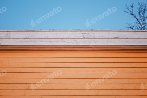 Preview: yellow wooden cabin in a sunset light