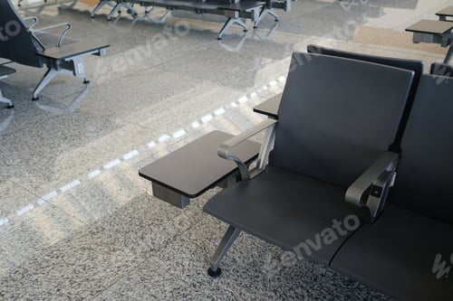 Preview: A recreation area in the modern airport terminal during the daytime with empty chairs