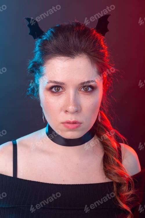 Preview: Halloween, holidays and carnival concept - vamp woman in collar and bat's ears in gothic style