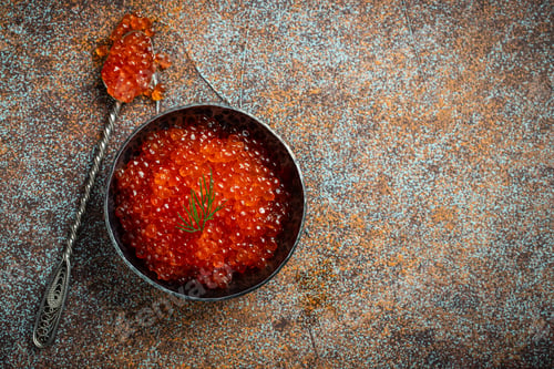 Preview: Delicious red caviar in black bowl.