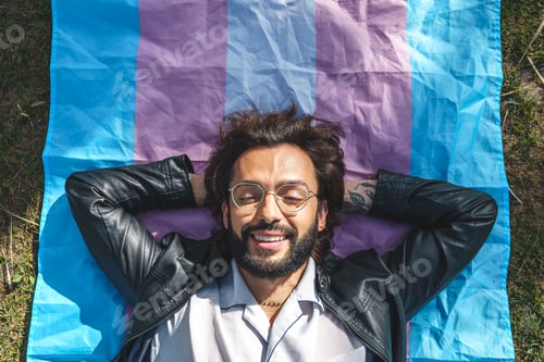 Preview: Positive man lying on transgender flag