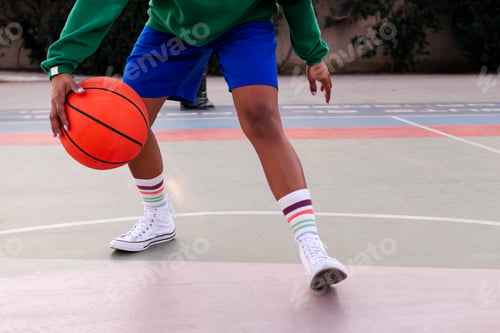 Preview: woman playing on a basketball court outdoors