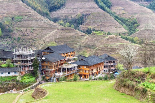 Preview: view of houses in village between terraced hills