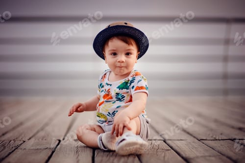 Preview: Little happy crawling baby boy on wooden floor