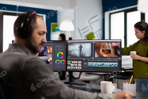 Preview: Videographer with headset working with footage and sound on pc