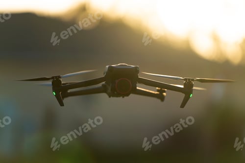 Preview: Drone with digital camera and fast rotating propellers flying taking video and pictures.