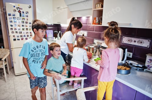 Preview: Mother with kids cooking at kitchen, happy children's moments.