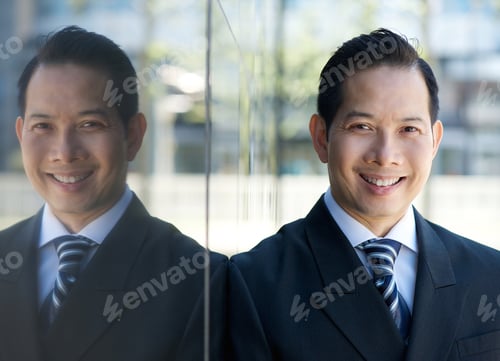 Preview: Businessman smiling with reflection