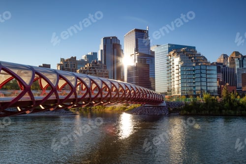 Preview: Peace Bridge across Bow River during a vibrant summer sunrise