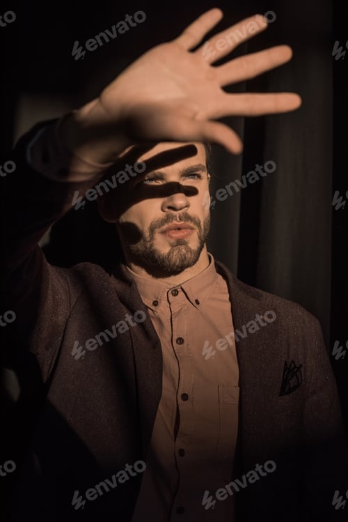 Preview: close-up view of stylish bearded young man showing palm