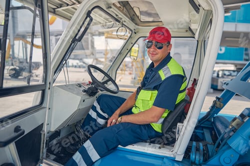 Preview: Calm airport worker sitting in a car