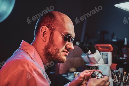 Preview: Serious watchmaker is repairing cutomer's order at his own repairing studio