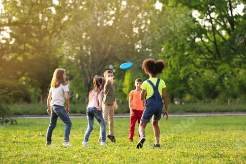 Preview: Cute little children playing with frisbee outdoors on sunny day