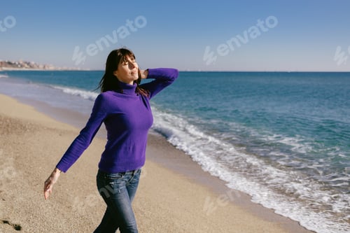 Preview: Beautiful woman happy and relaxed on the beach