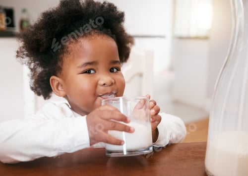 Preview: This is so my bones grow strong. Shot of a little girl enjoying a glass of milk.