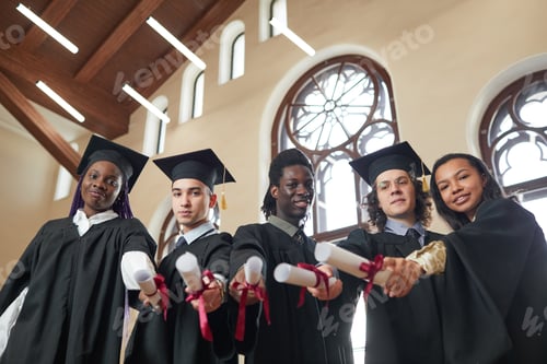 Preview: A group of people in graduation gowns indoors