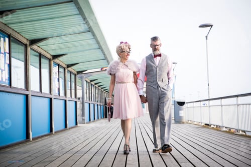Preview: 1950's vintage style couple strolling and holding hands on pier