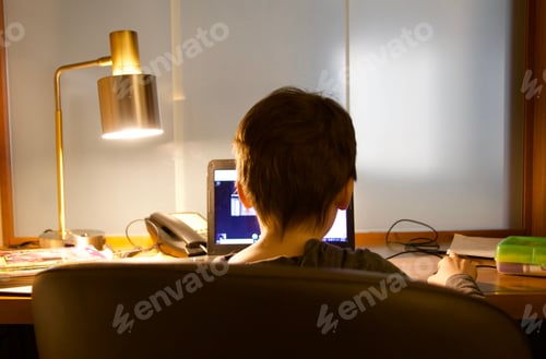 Preview: Child doing virtual school at hotel desk during coronavirus