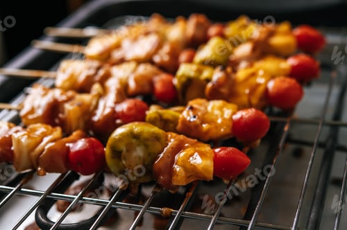 Preview: BBQ grill with a variety of meats, complete with tomatoes and bell peppers.