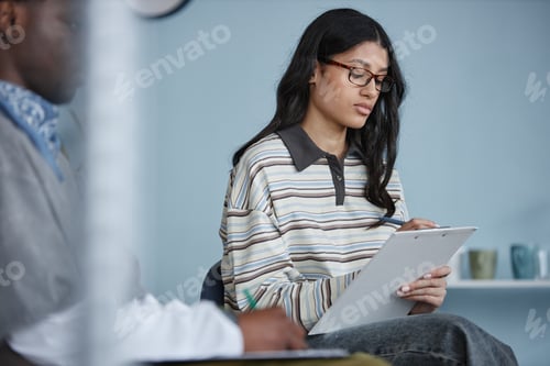 Preview: Teenage Girl Taking Notes during Counseling Session with Group