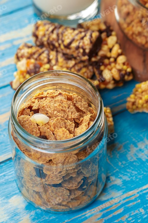 Preview: Cereal and snack bars on a blue wooden table in a kitchen setting