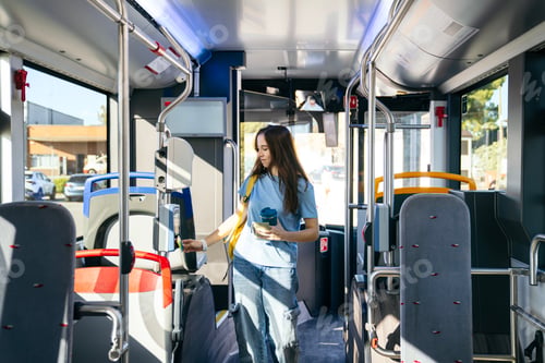 Preview: Woman paying for public transport using contactless card