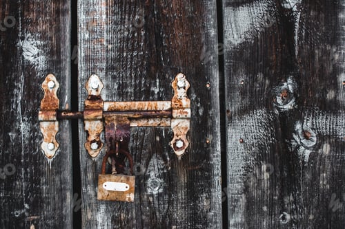 Preview: old weathered rusty lock on wooden frosty door