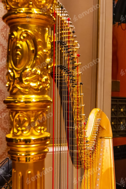 Preview: Beautiful golden harp strings close up. Musical instruments of the Orchestra in philharmonia