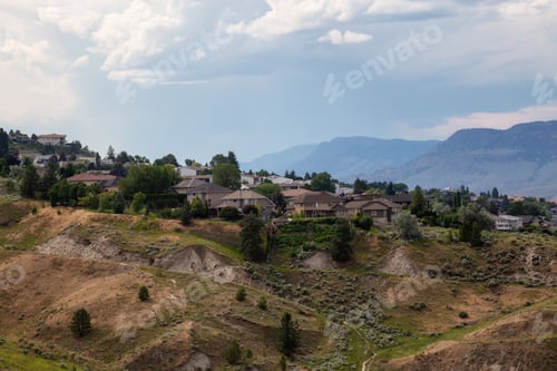Preview: Aerial view of homes on top of a hill during a cloudy summer day