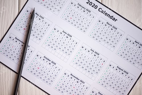 Preview: Top view of 2020 calendar and pencil on wooden background