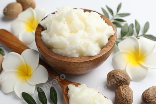 Preview: Shea butter, nuts, plumeria flowers and leaves on white background, closeup