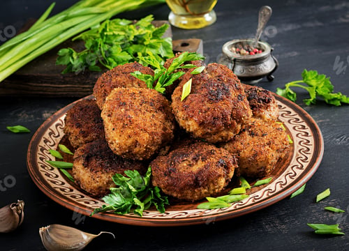Preview: Juicy delicious meat cutlets on a dark table. Russian cuisine.