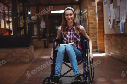Preview: Disabled schoolgirl on wheelchair in corridor at school