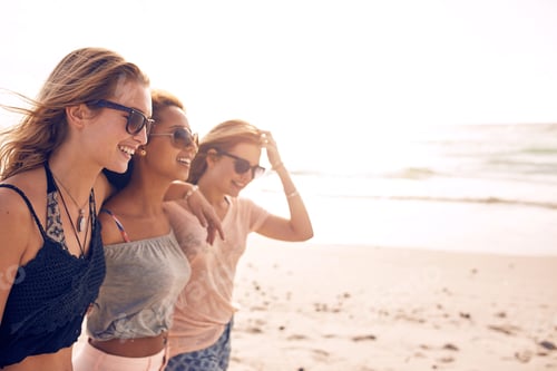Preview: Happy young women walking on a beach