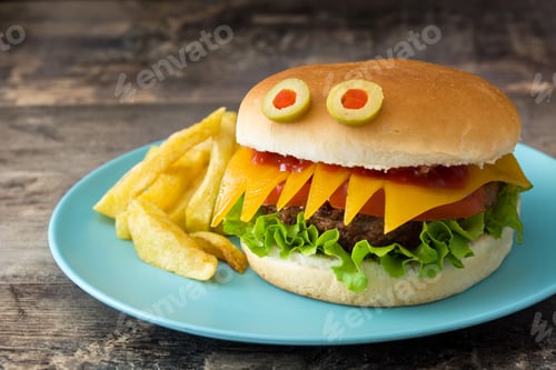 Preview: Monster halloween cheeseburger with french fries on turquoise plate