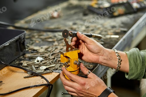 Preview: Locksmith in workshop makes new key, use grinding engraving machine