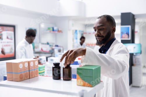 Preview: Black pharmacist checking pharmacy shelves filled with medicine