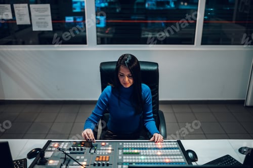 Preview: Middle aged woman using equipment in control room on a tv station