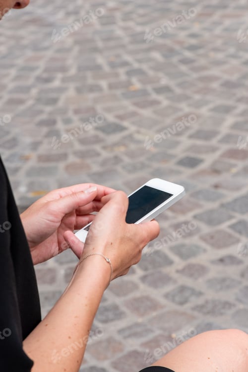 Preview: female hands holding mobile phone outside