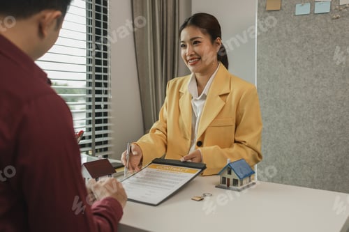 Preview: A man signs a contract after agreeing to buy a house with an agent. The agent explains the details o