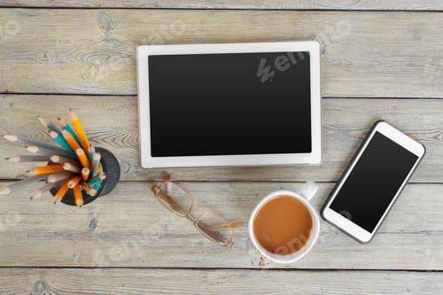 Preview: digital tablet and coffee cup on wooden table