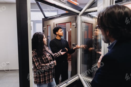 Preview: People discussing modern windows in a showroom