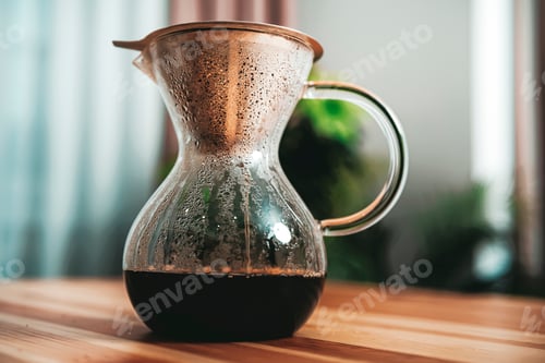 Preview: Finished dark coffee in glass Chemex with steam and condensation drops