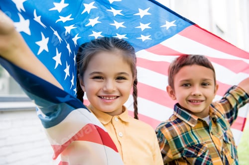 Preview: smiling brother and sister with american flag