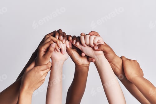 Preview: Shot of a group of hands holding on to each other against a white background