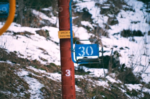 Preview: Old vintage ski lift with colorful chairs