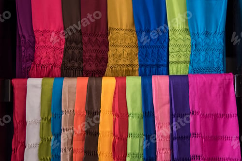 Preview: A row of colorful scarves are displayed in a store