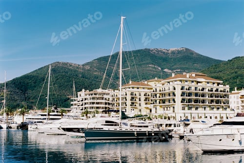 Preview: Luxury yachts by the coast with expensive villas in Porto. Montenegro
